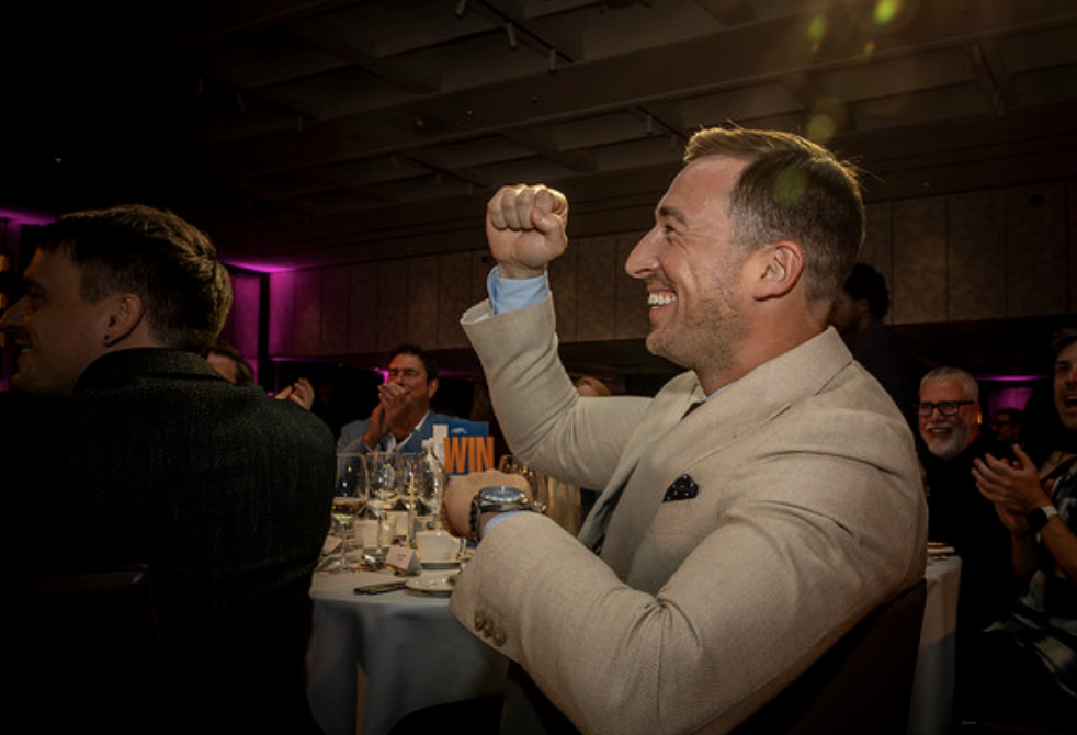 Hashting team member celebrating at the table